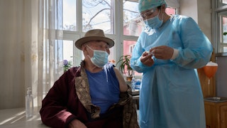 A nurse showing a patient a vaccine.