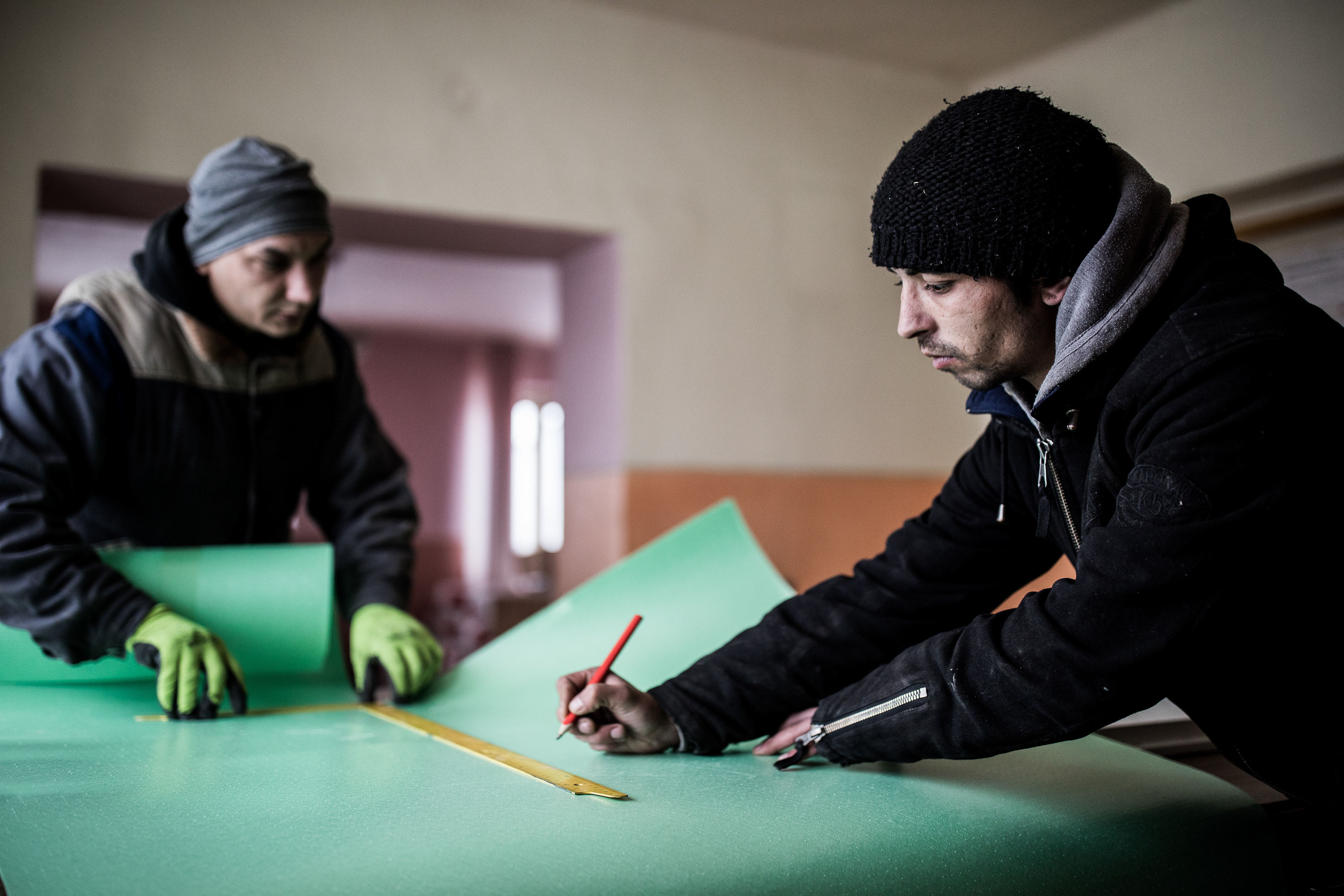 Two men work at a workbench