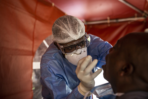 A doctor administering a COVID-19 test