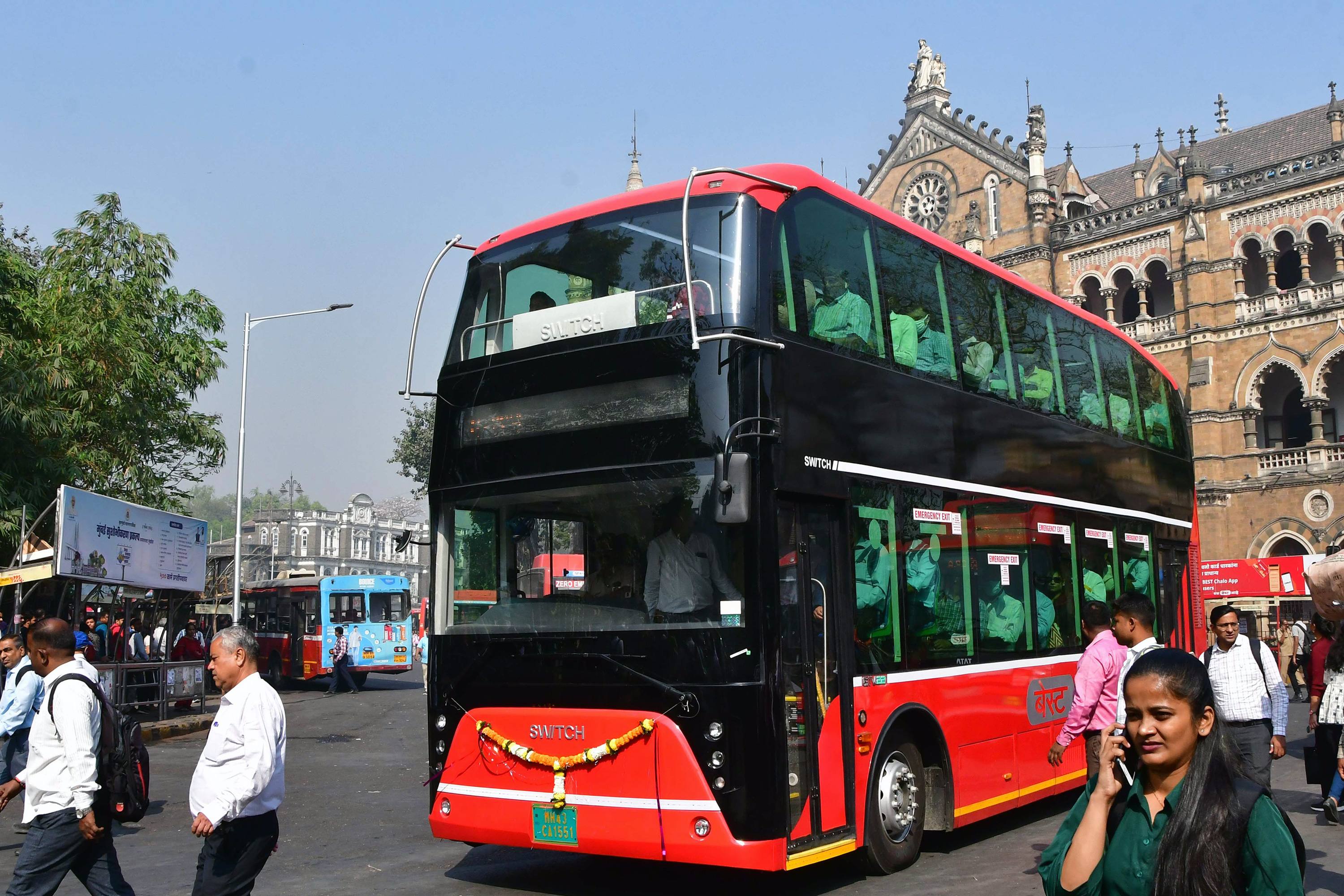 Commuters ride an electric double-decker bus in Mumbai.