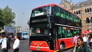 Commuters ride an electric double-decker bus in Mumbai.