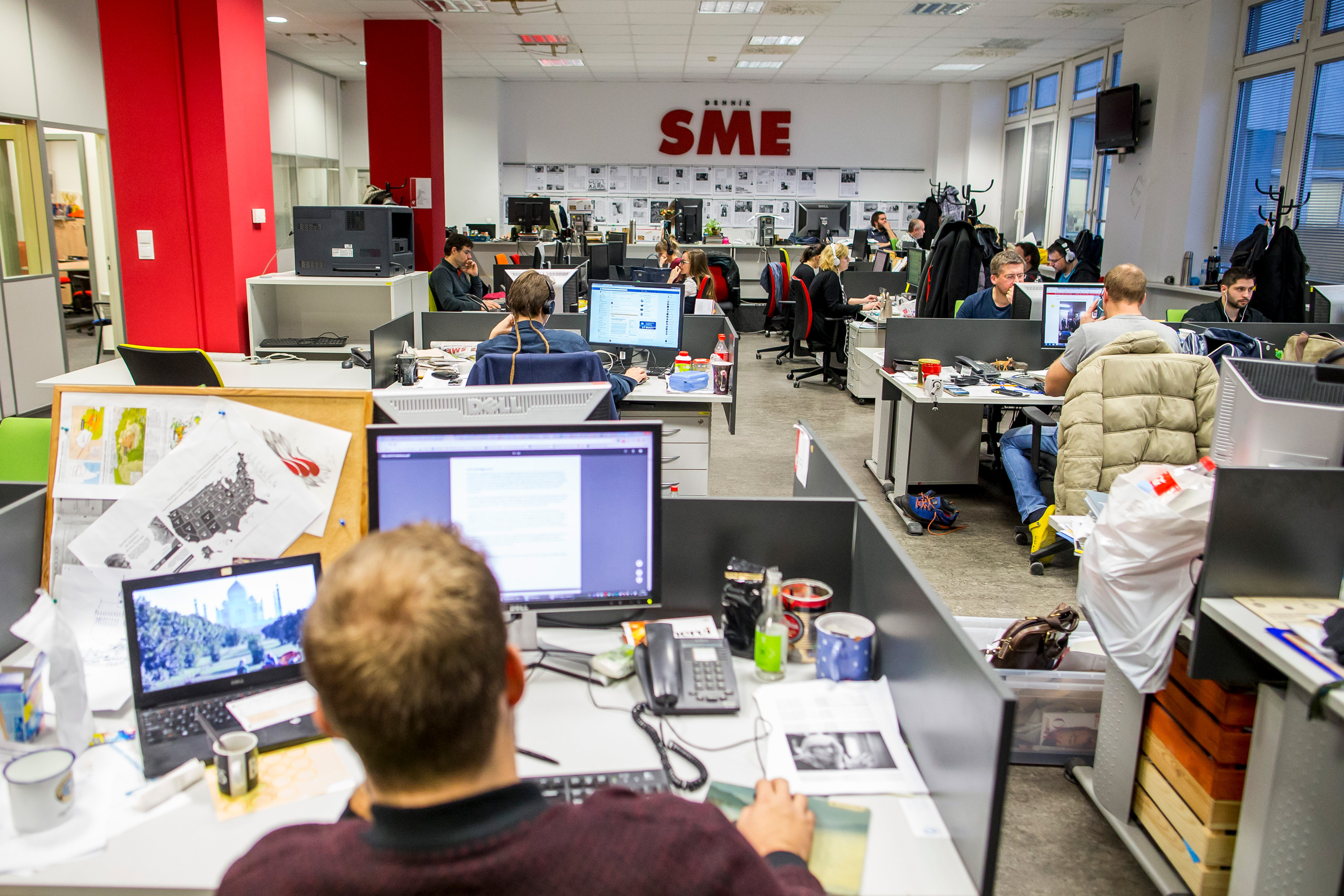 People sitting at desks in a newsroom