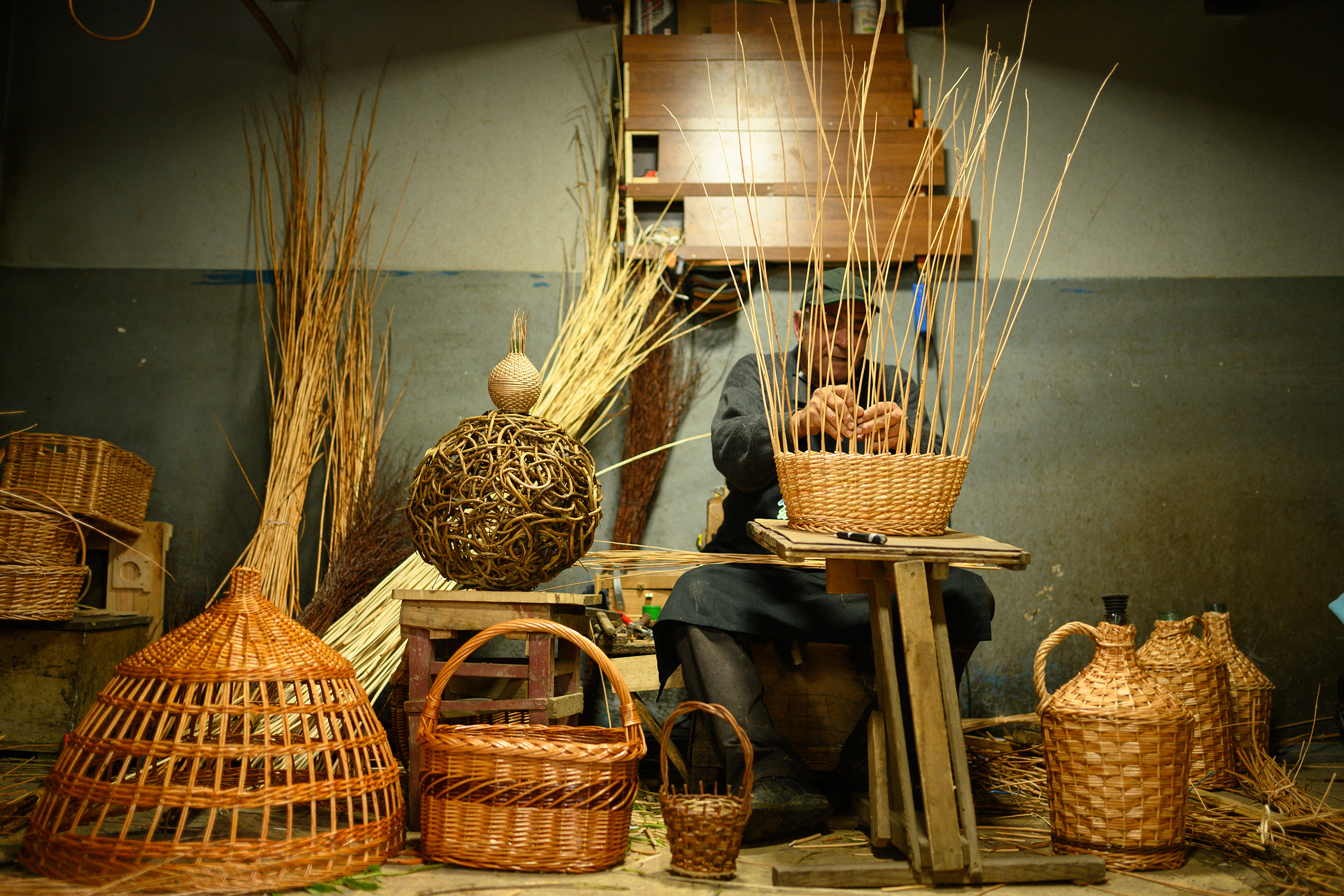 A man weaving a basket by hand