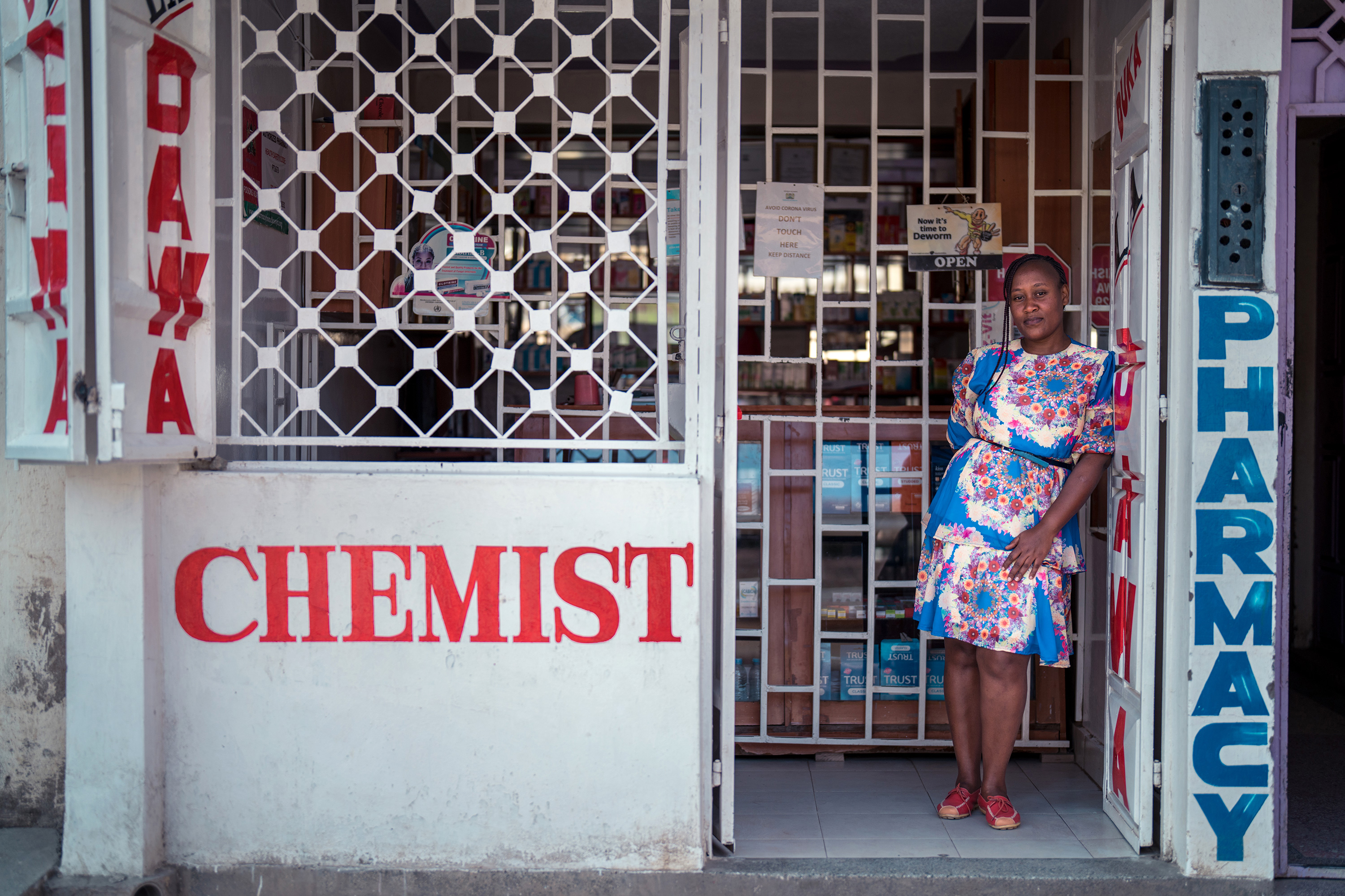 A woman standing at the entrance of a building