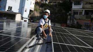 A person working on solar panels on a rooftop