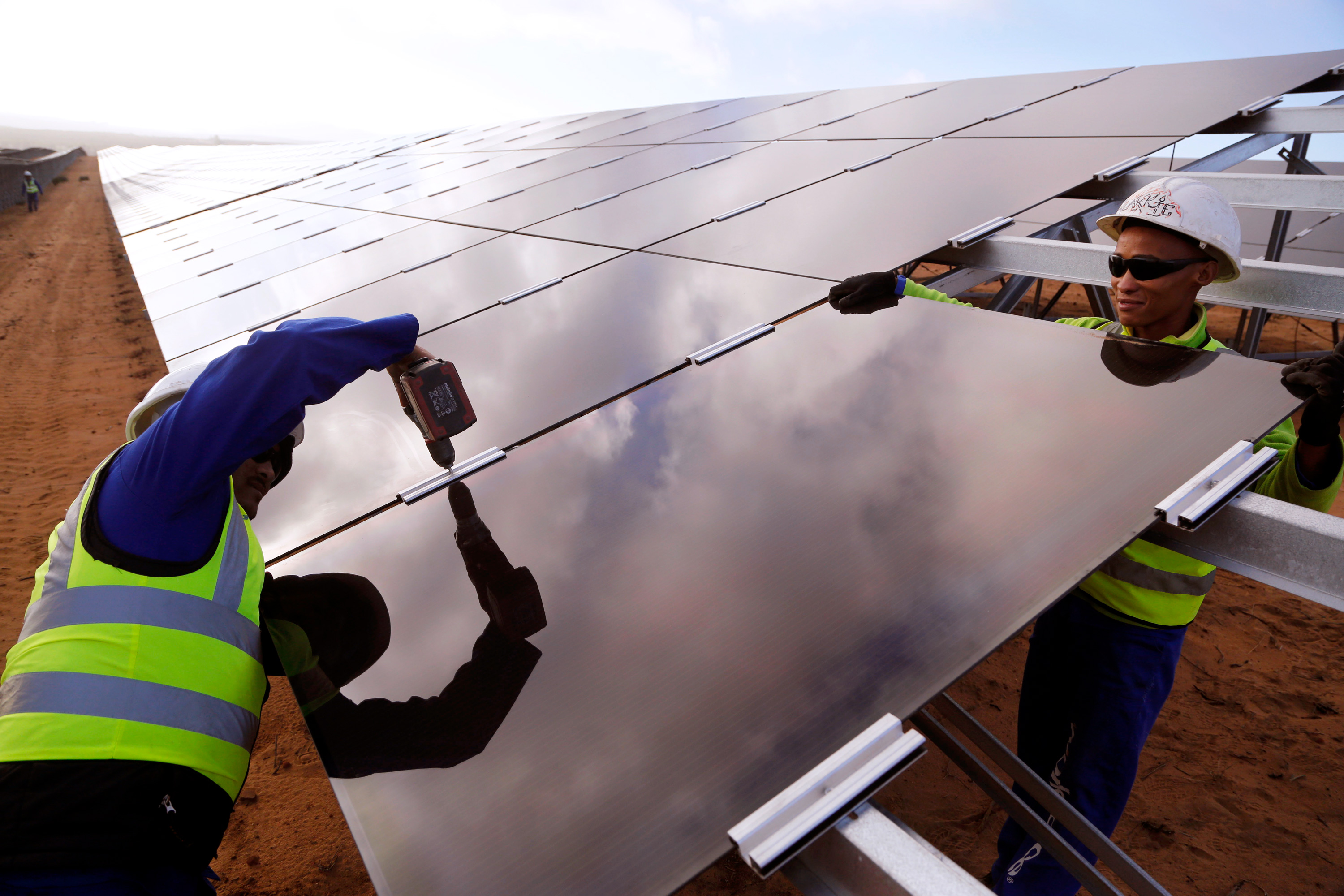 Two workers installing a solar panel